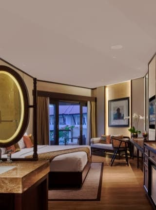 Deluxe Room - Elegant bedroom with illuminated mirror and balcony view