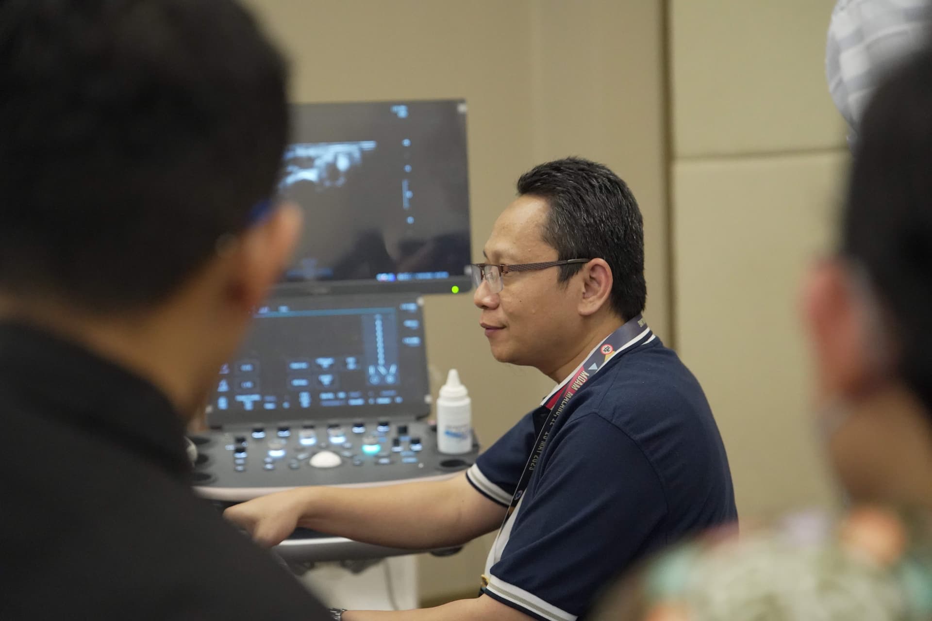 Healthcare professional operating ultrasound machine during training workshop