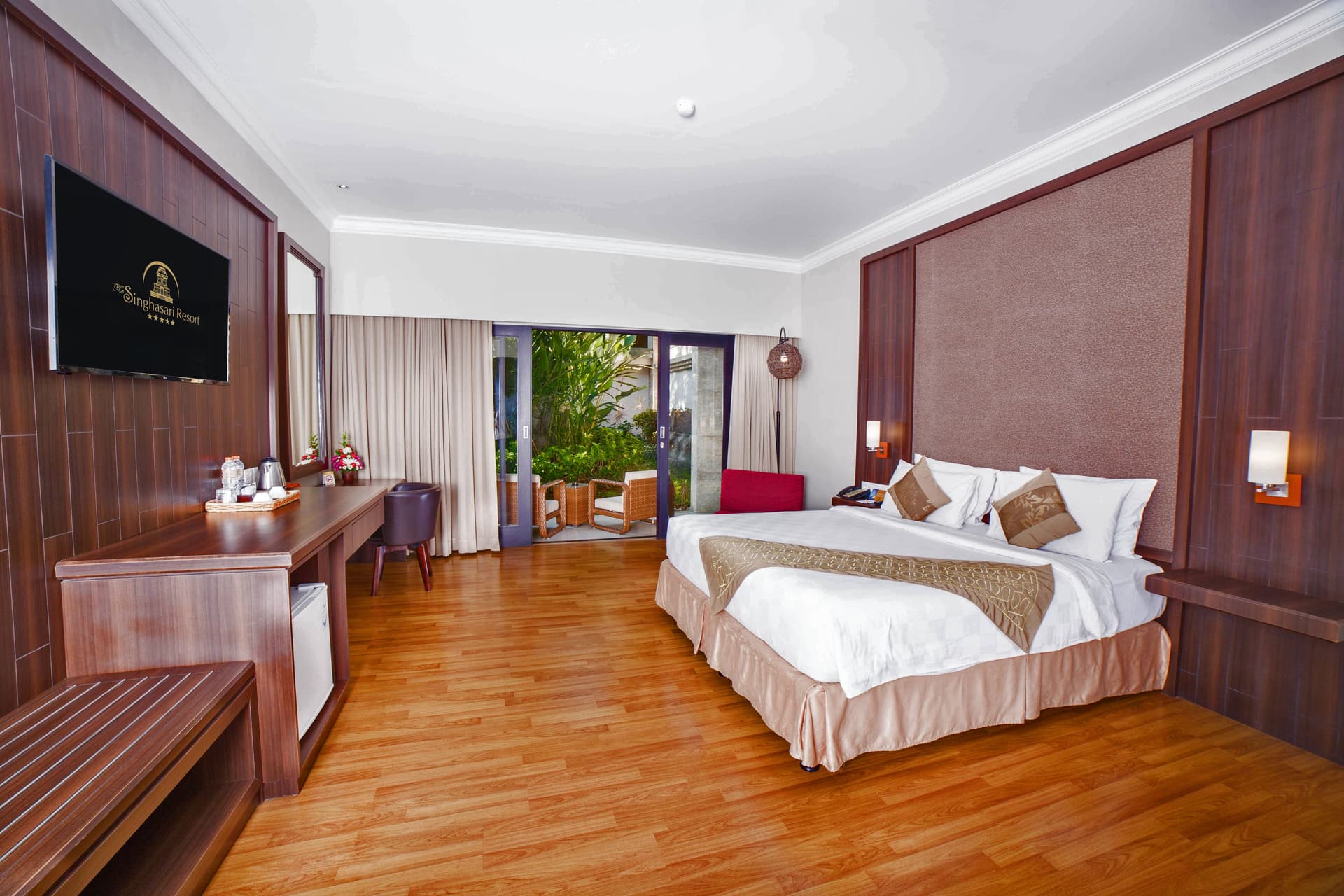 Premier Room - Spacious bedroom with king bed, TV, and balcony access